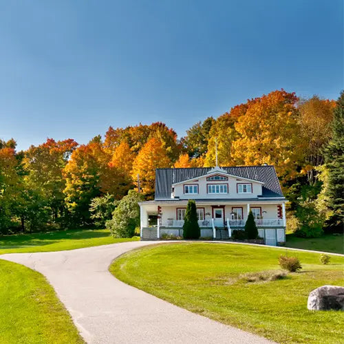 Beautiful off-grid home surrounded by fall foliage, powered by solar energy for sustainable and independent living