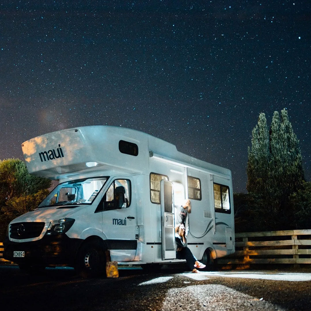 RV with solar panels parked under the stars, perfect for off-grid camping and outdoor adventures