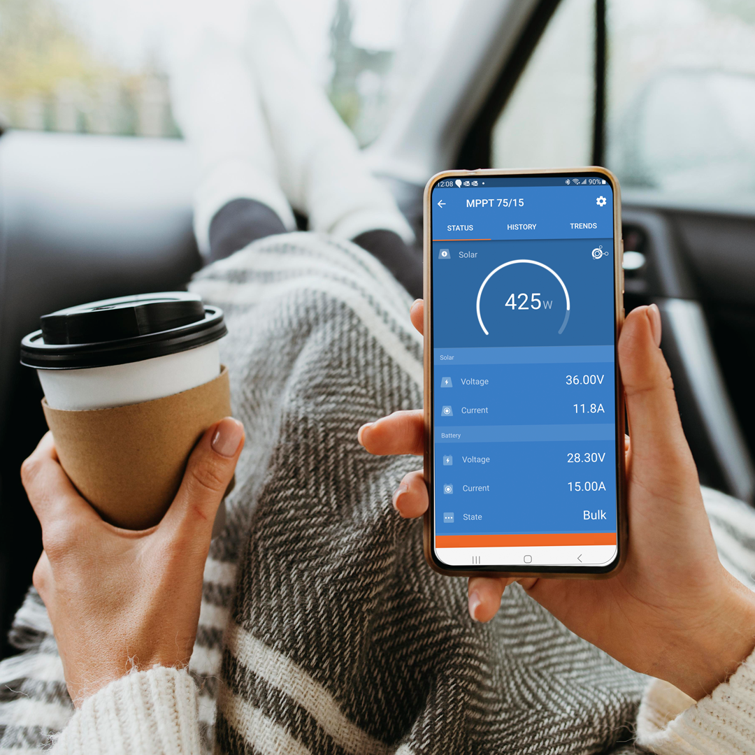 Person using Victron Energy app to monitor solar performance and battery status