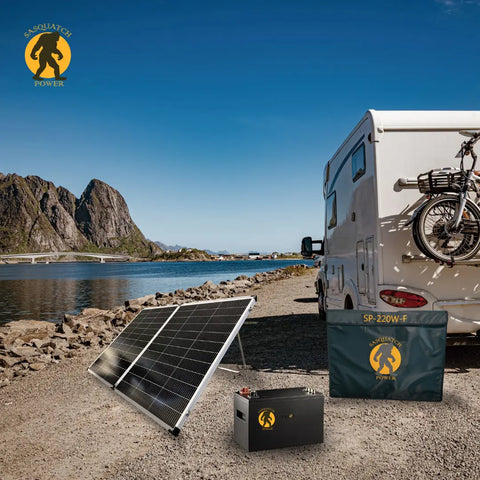 Portable Sasquatch Power solar kit with battery and panels charging an RV near a lake, off-grid adventure setup.